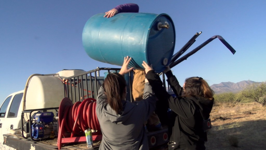 Students help replace a water barrel with Humane Borders
