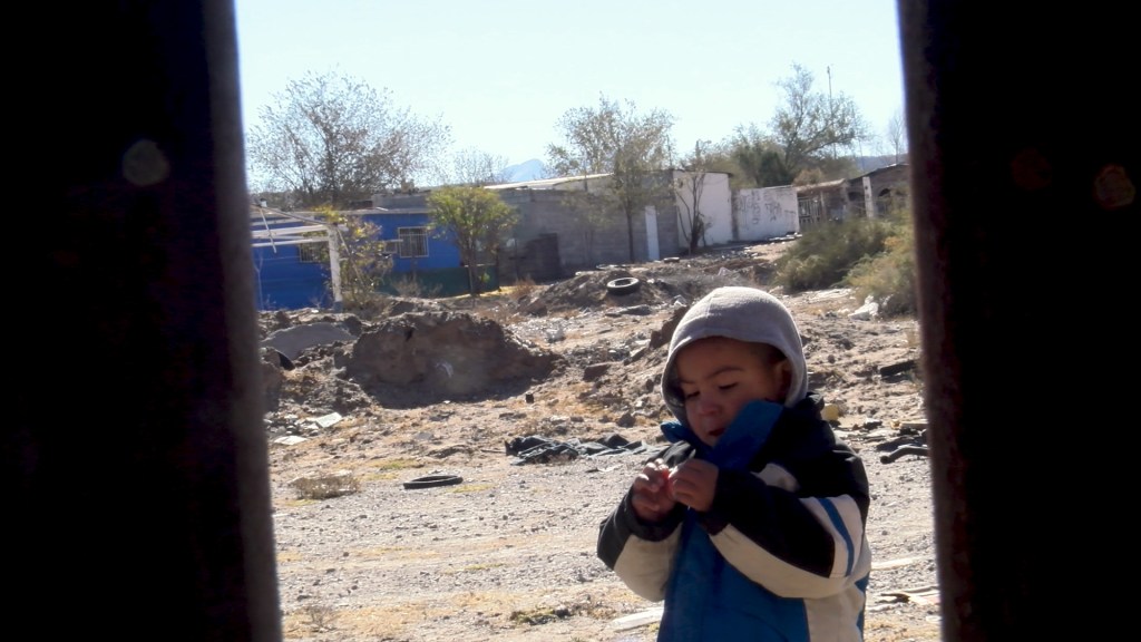 A young boy is seen through the wall located between Juarez and El Paso